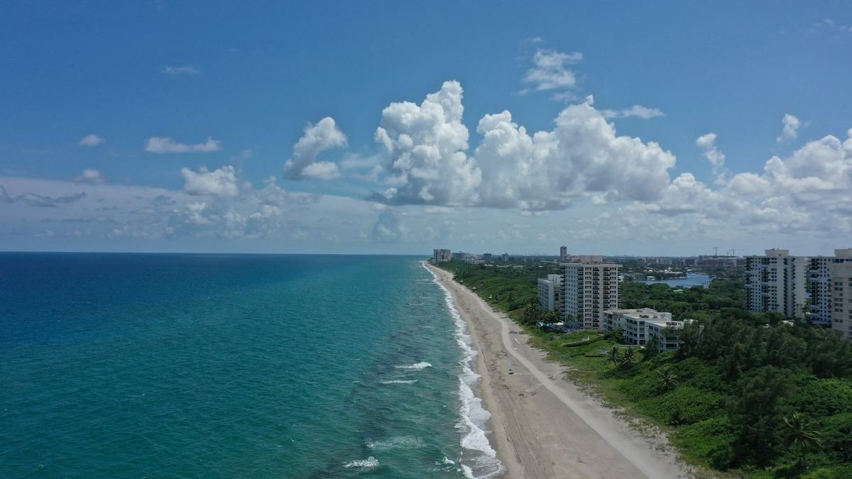 Aerial view of the South Florida coastline at Boca Raton, with the ocean, beach and buildings along the shore.
