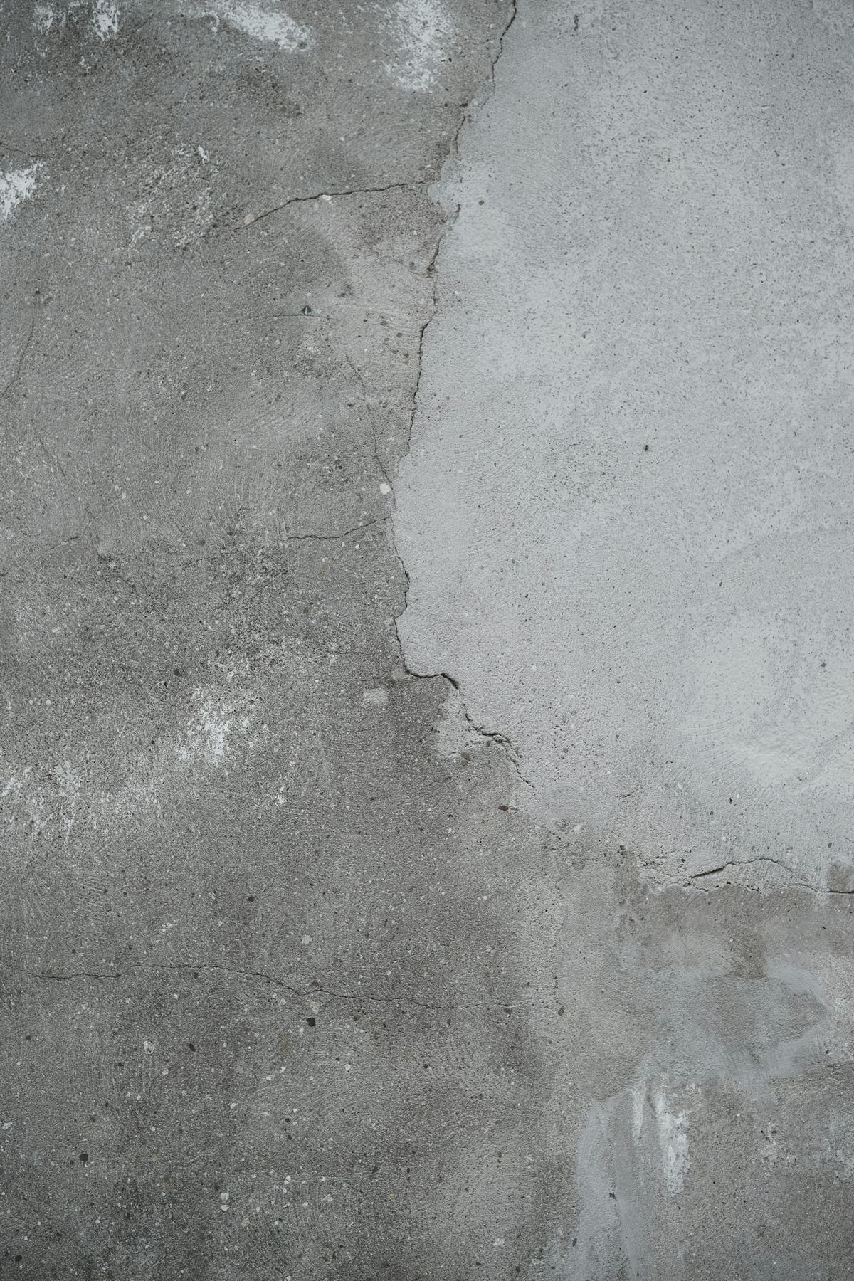 Concrete surface showing the edge between an older area and a newer patch.