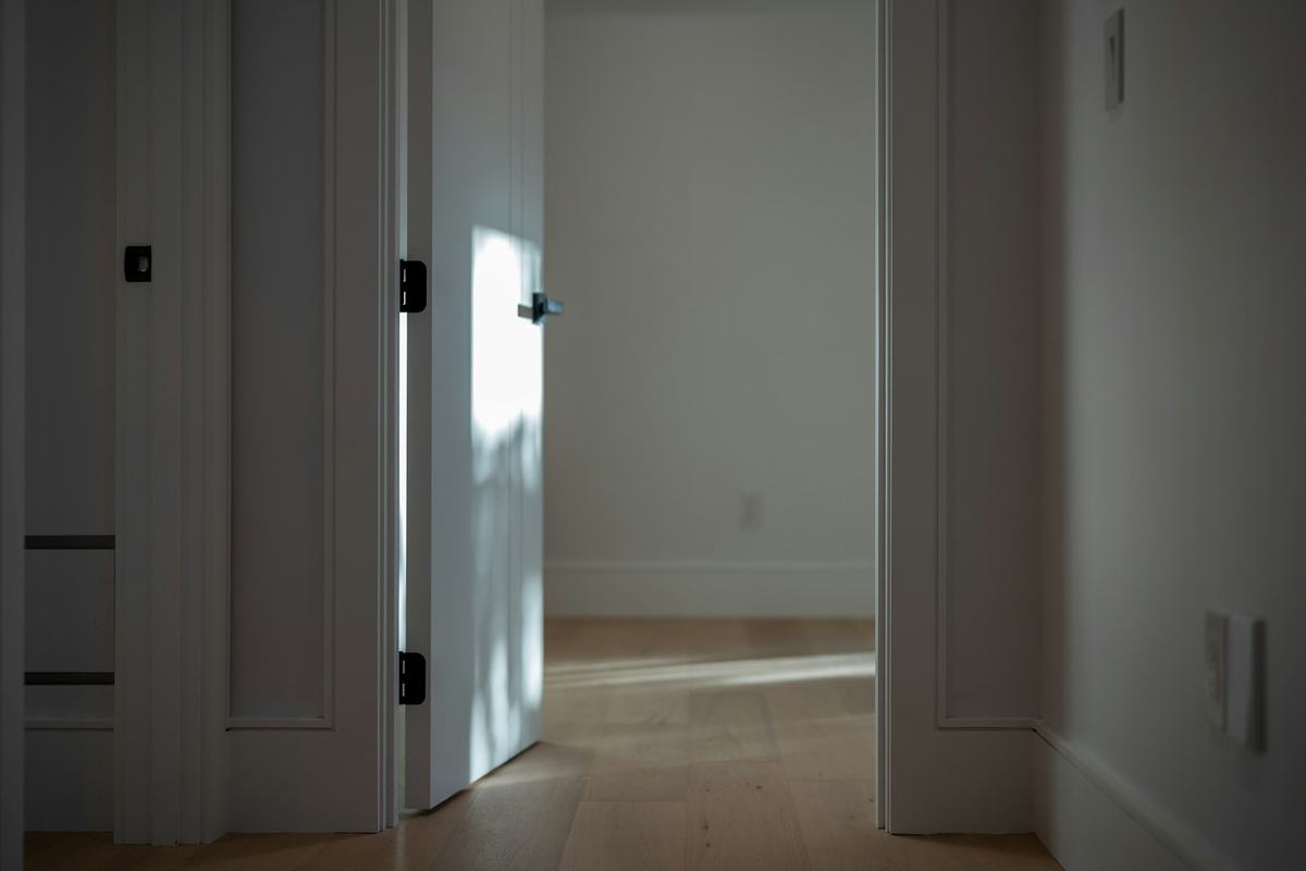 White paneled interior doors standing open along a hallway.