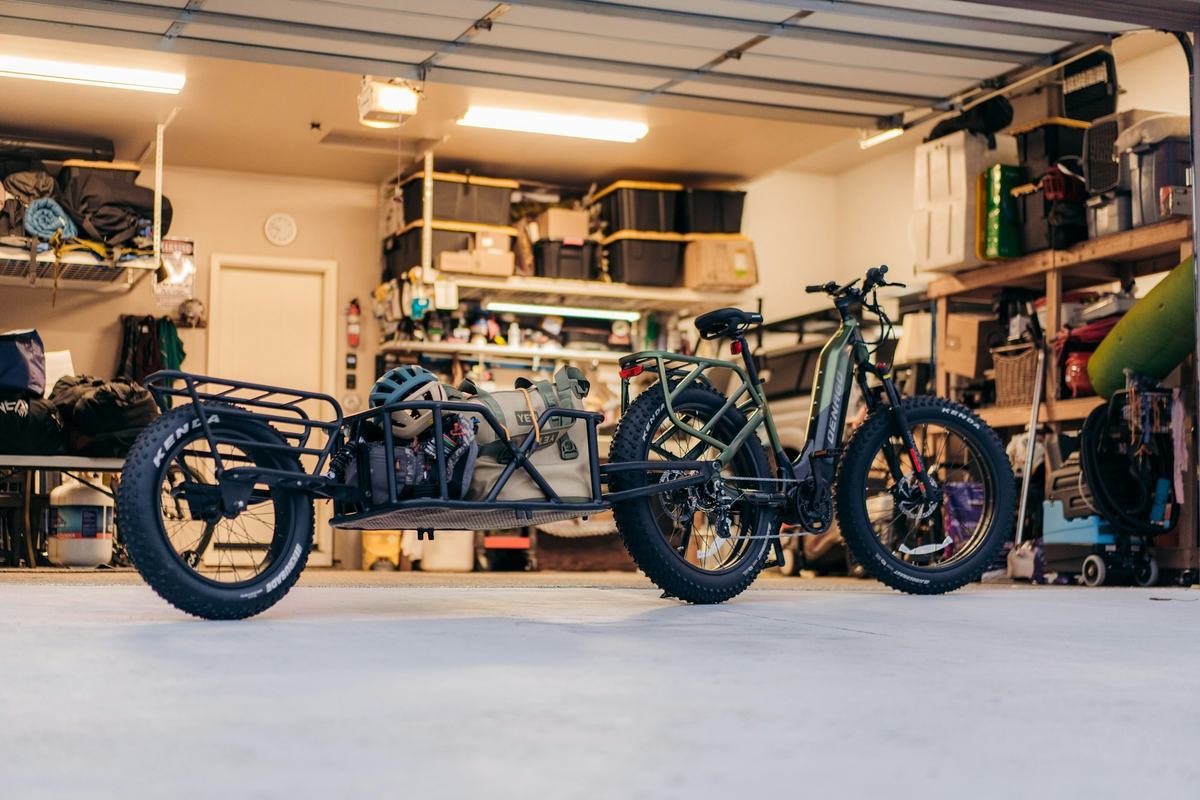 Organized residential garage with storage shelving and a light-gray floor.